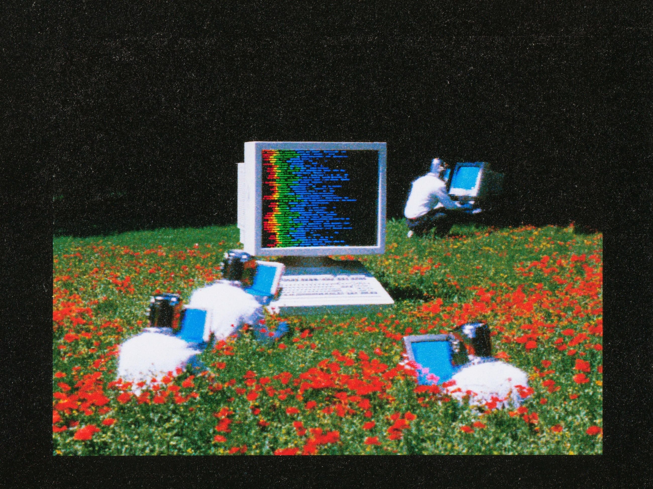Retro computer monitors and AI bots gathered in a wildflower field, representing AI crawlers reaching website content for Google AI Search